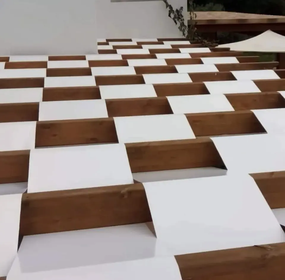 Checkerboard terrace of white slabs and raised timber squares